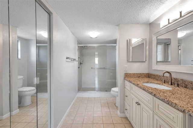 bathroom with an enclosed shower, vanity, tile patterned flooring, and toilet