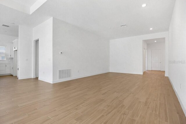 spare room with light hardwood / wood-style flooring