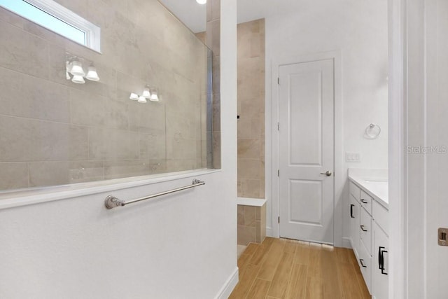 bathroom with wood finished floors and vanity