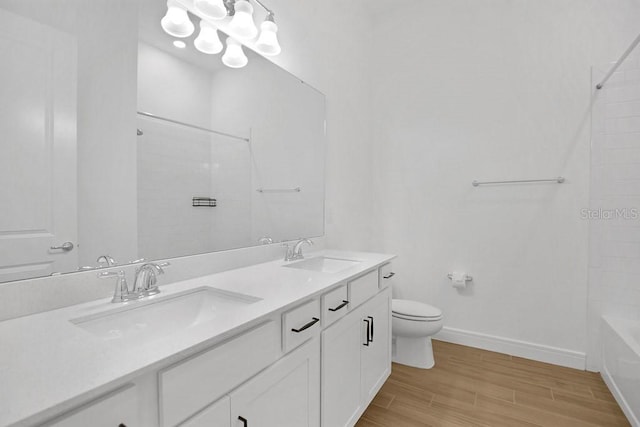 full bathroom featuring tub / shower combination, wood-type flooring, toilet, and double vanity