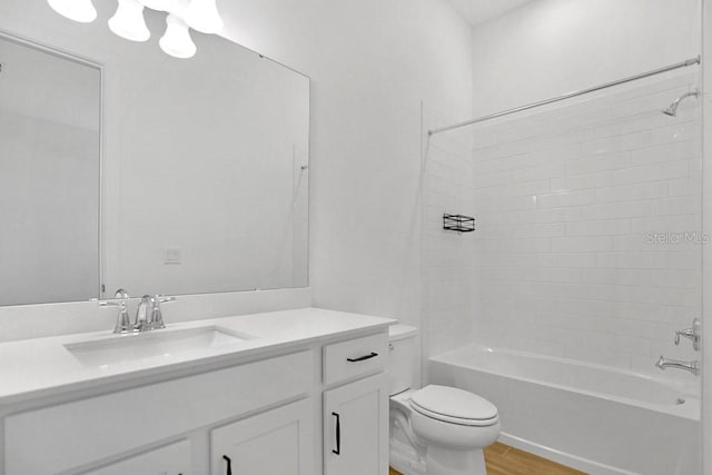 full bath featuring toilet,  shower combination, wood finished floors, and vanity