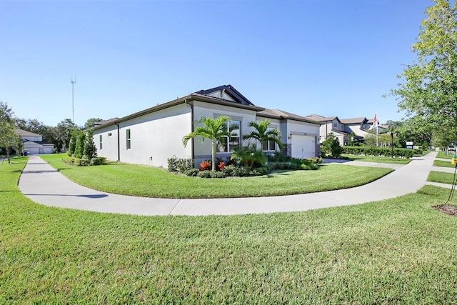 view of home's exterior featuring a residential view, a lawn, an attached garage, and stucco siding