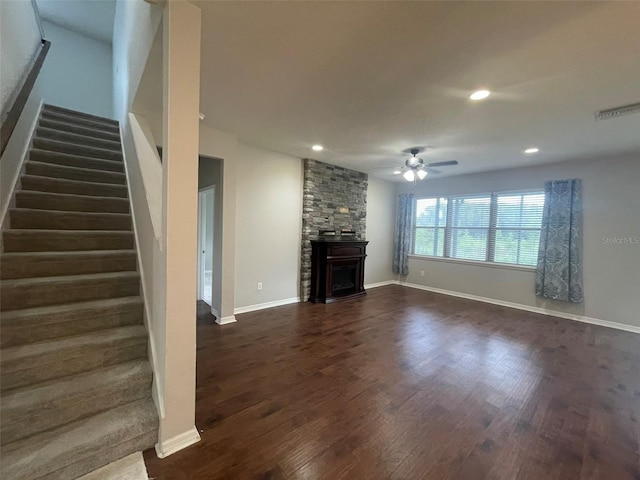 unfurnished living room with ceiling fan and dark wood-type flooring