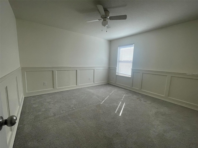 spare room featuring light carpet and ceiling fan