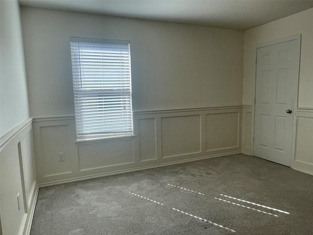 spare room featuring light carpet