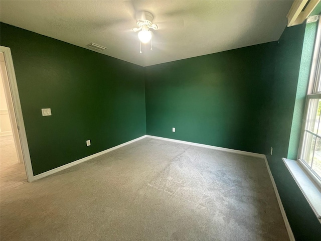 spare room featuring ceiling fan and carpet floors