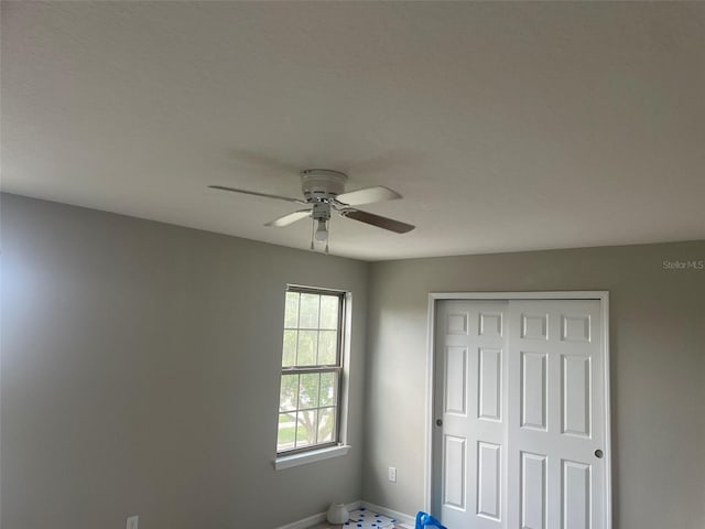 unfurnished bedroom featuring a closet and ceiling fan