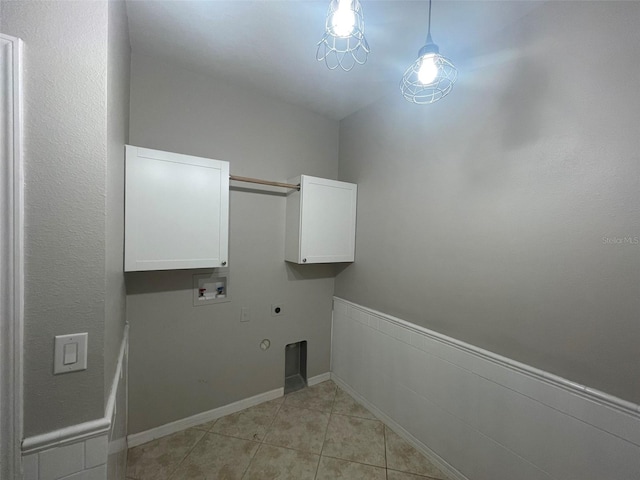 laundry area featuring cabinets, gas dryer hookup, hookup for a washing machine, electric dryer hookup, and light tile patterned flooring