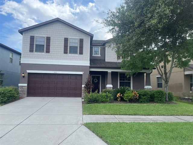 view of front of property with a front yard and a garage