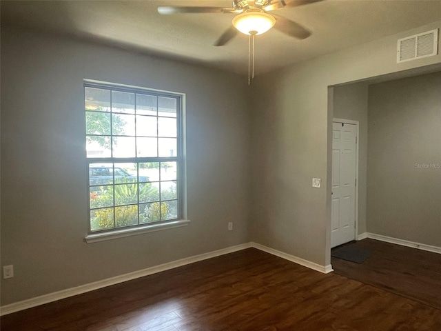 spare room with ceiling fan and dark hardwood / wood-style floors