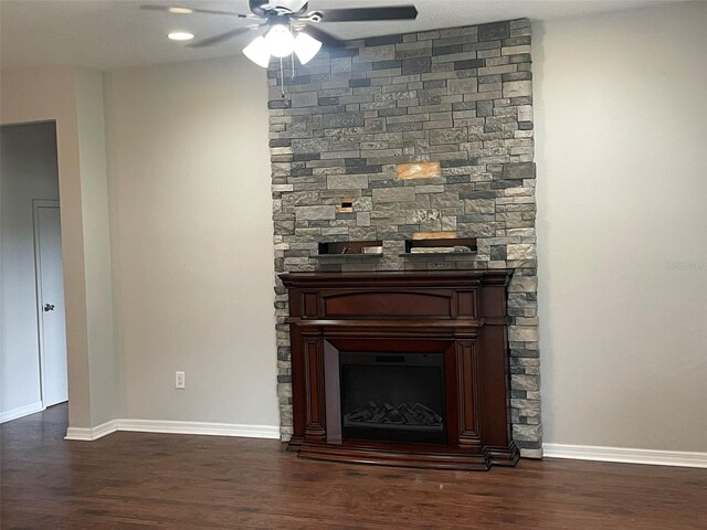 room details with hardwood / wood-style flooring, ceiling fan, and a fireplace