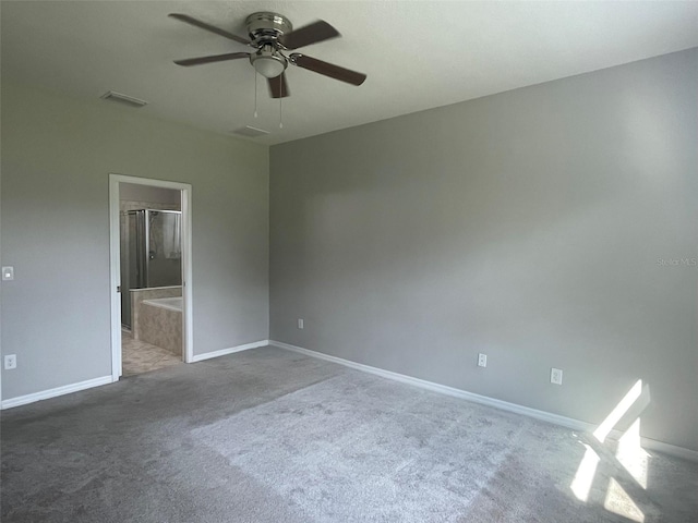 unfurnished bedroom featuring carpet flooring, ceiling fan, and ensuite bath