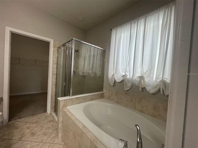 bathroom featuring shower with separate bathtub and tile patterned flooring