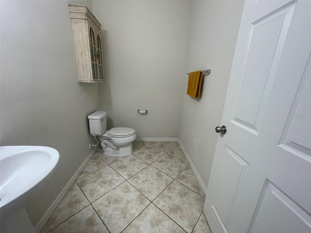 bathroom featuring sink, toilet, and tile patterned floors