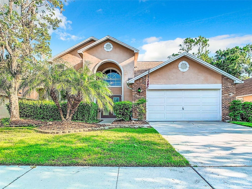 view of front of property featuring a garage and a front lawn