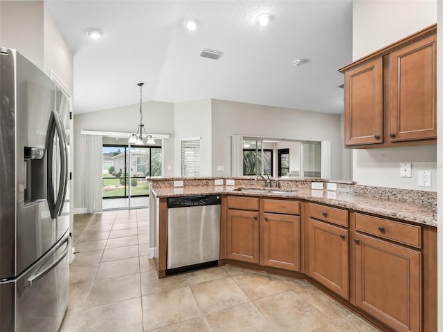 kitchen featuring hanging light fixtures, appliances with stainless steel finishes, light stone countertops, sink, and light tile patterned flooring