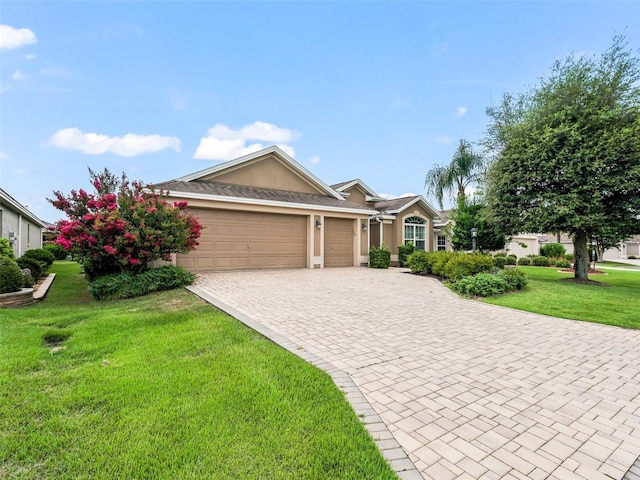 ranch-style house featuring a front lawn, decorative driveway, an attached garage, and stucco siding