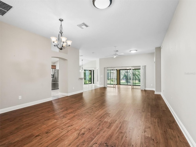 unfurnished room with baseboards, visible vents, and wood finished floors