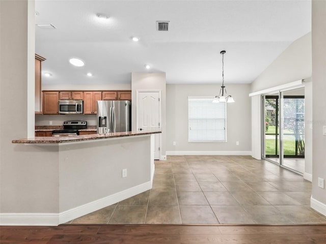 kitchen featuring pendant lighting, brown cabinets, stainless steel appliances, recessed lighting, and vaulted ceiling