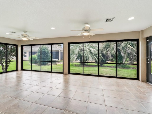 unfurnished sunroom featuring ceiling fan and visible vents