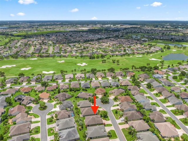 drone / aerial view with a residential view and golf course view