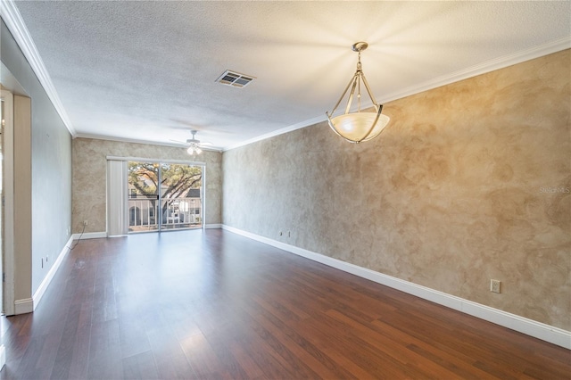 unfurnished room with visible vents, crown molding, a ceiling fan, and wood finished floors