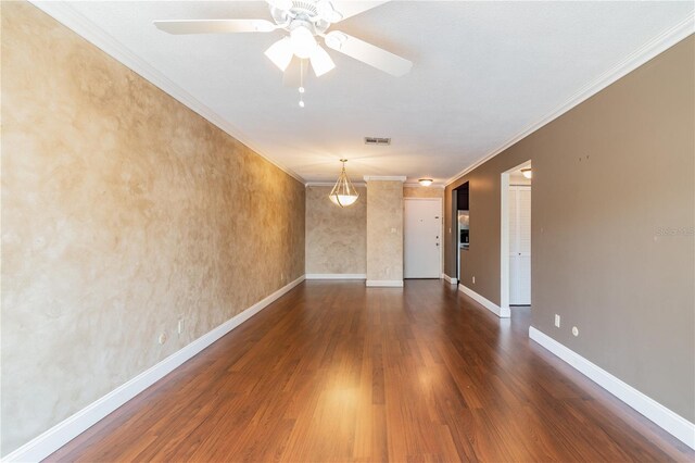 empty room with ceiling fan, ornamental molding, and dark hardwood / wood-style floors