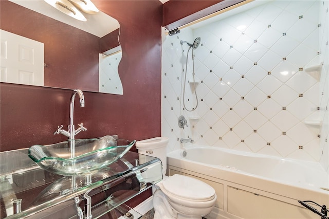 full bathroom featuring tiled shower / bath, toilet, and vanity