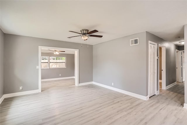 empty room featuring ceiling fan and light hardwood / wood-style floors