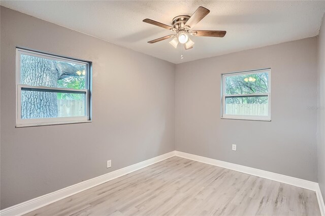 unfurnished room with ceiling fan and light hardwood / wood-style flooring