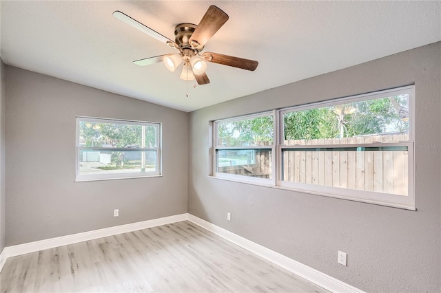 unfurnished room with light hardwood / wood-style floors, ceiling fan, and lofted ceiling