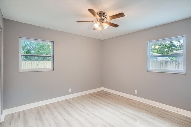 unfurnished room featuring light hardwood / wood-style flooring, a wealth of natural light, and ceiling fan