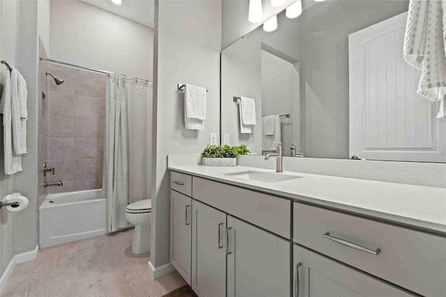 full bathroom featuring vanity, wood-type flooring, shower / bath combination with curtain, and toilet