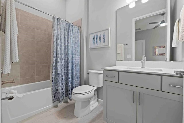 full bathroom featuring ceiling fan, vanity, toilet, and shower / tub combo