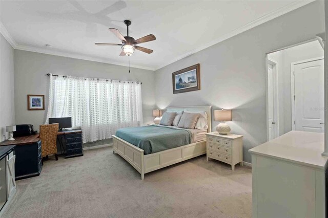 carpeted bedroom with ceiling fan and ornamental molding