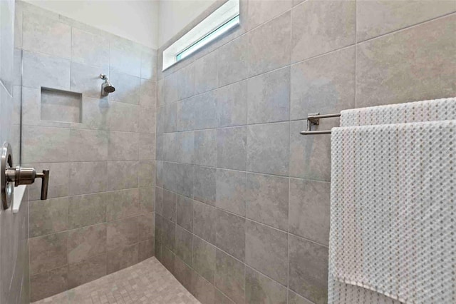 bathroom with a tile shower