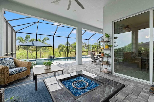 sunroom featuring ceiling fan and plenty of natural light