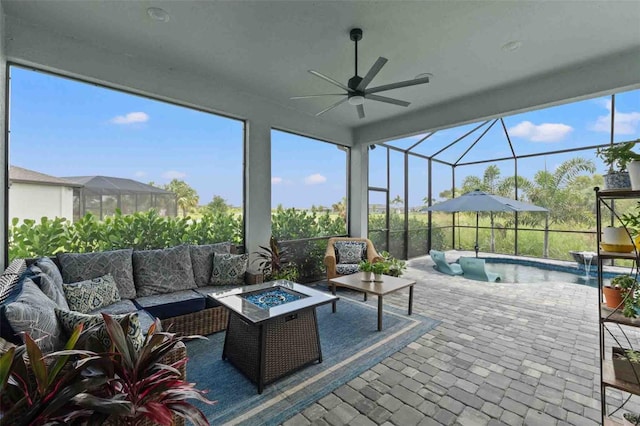 sunroom / solarium featuring ceiling fan and a healthy amount of sunlight