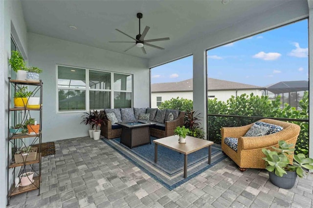 sunroom / solarium featuring ceiling fan