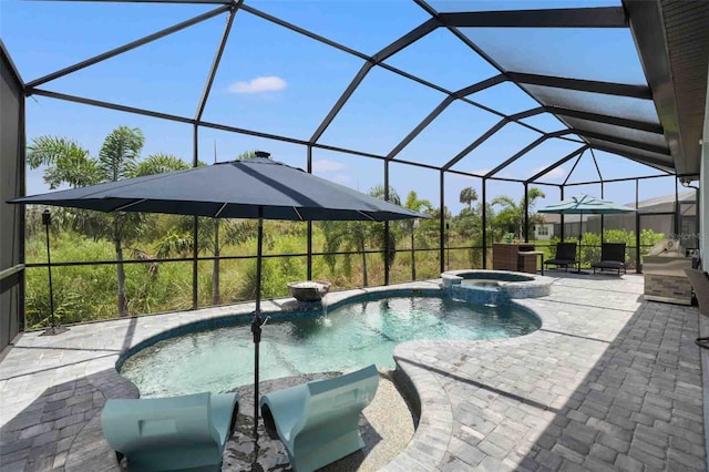 view of pool with an in ground hot tub, a patio, and glass enclosure