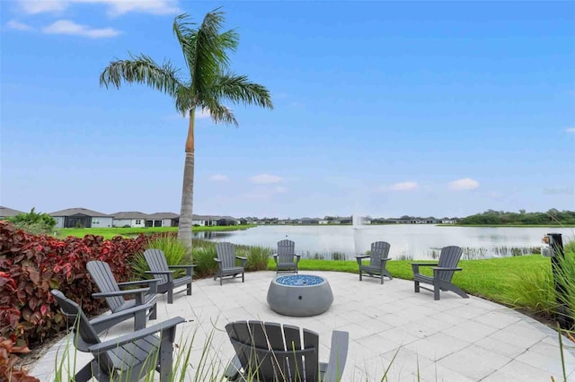 view of patio / terrace with a water view and an outdoor fire pit