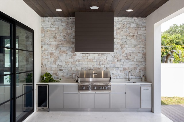 view of patio with an outdoor kitchen, area for grilling, and a sink