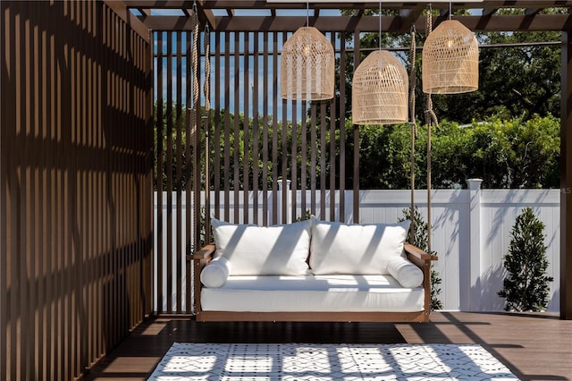 view of patio featuring outdoor lounge area, fence, and a wooden deck