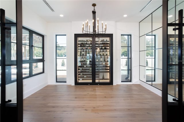 entryway with a chandelier, recessed lighting, and wood finished floors