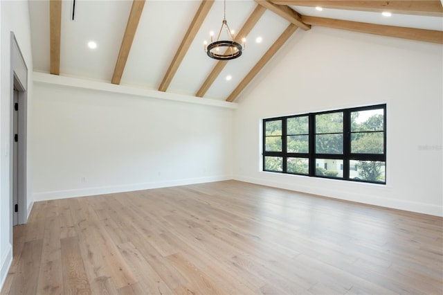 unfurnished living room featuring baseboards, a chandelier, light wood-style flooring, beamed ceiling, and high vaulted ceiling