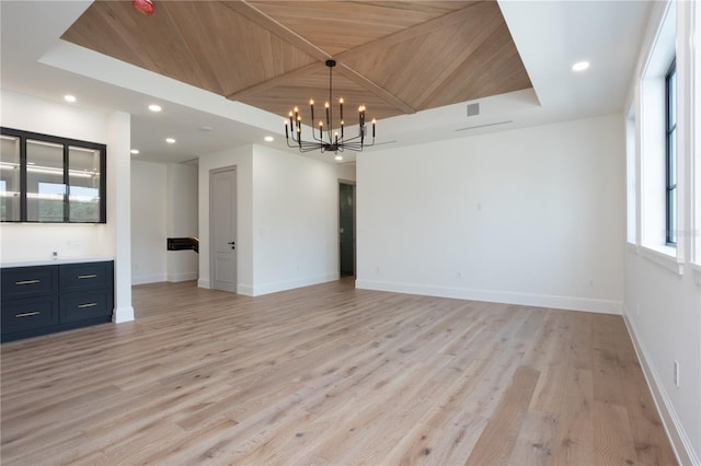 spare room with light wood-style flooring, a notable chandelier, recessed lighting, wood ceiling, and baseboards