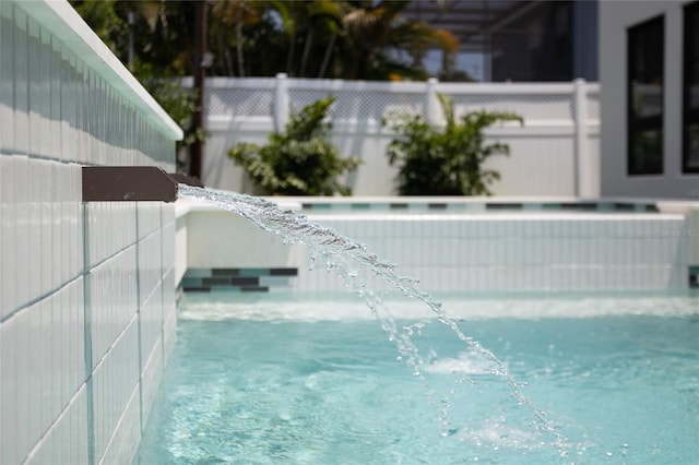 view of swimming pool featuring fence