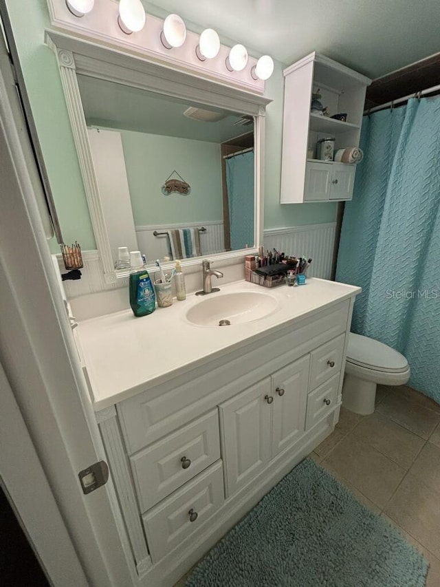 bathroom with tile patterned floors, toilet, and vanity