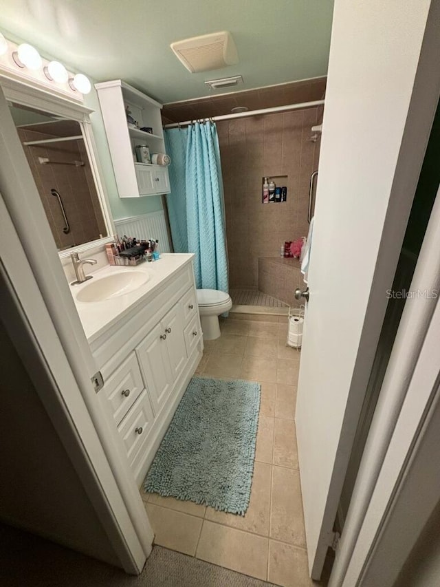 bathroom featuring tile patterned floors, a shower with curtain, vanity, and toilet