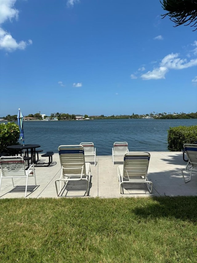 view of home's community featuring a lawn and a water view